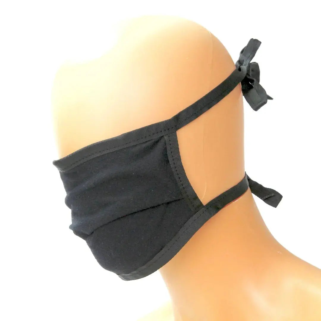 Black cotton face mask with adjustable tie straps on a mannequin head.
