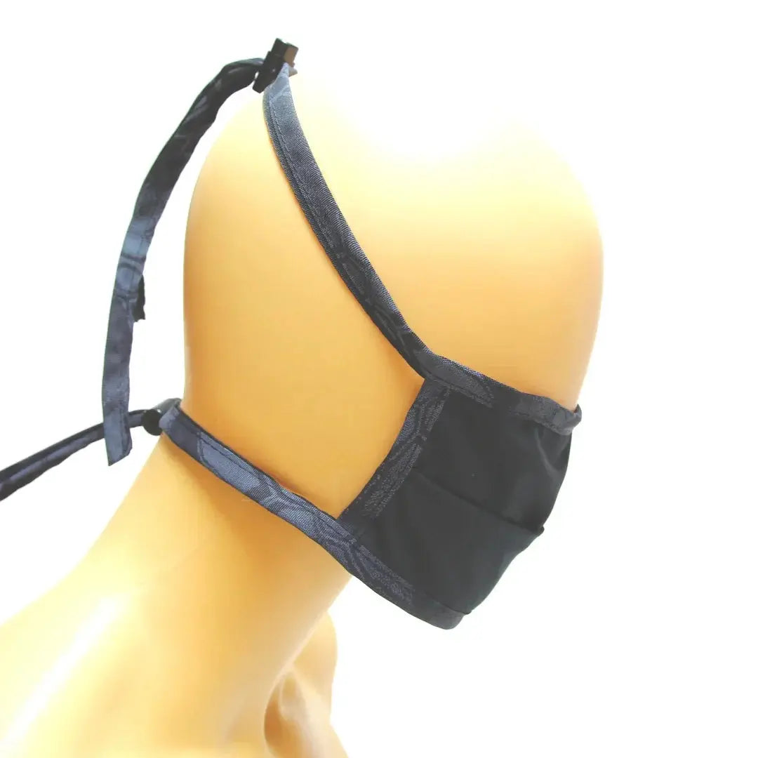 Black cotton face mask with adjustable ties and nose wire on mannequin.