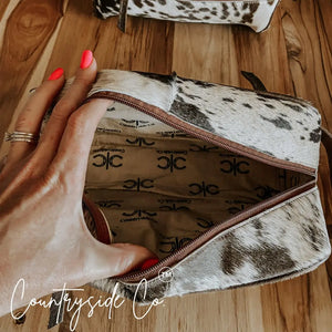 Countryside Co. cowhide toiletry bag with zipper.