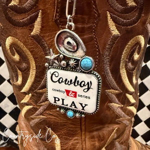 Cowboy Play Statement Necklace charm attached to a brown leather cowboy boot.