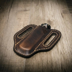Brown leather trapper knife sheath with white stitching and bull logo