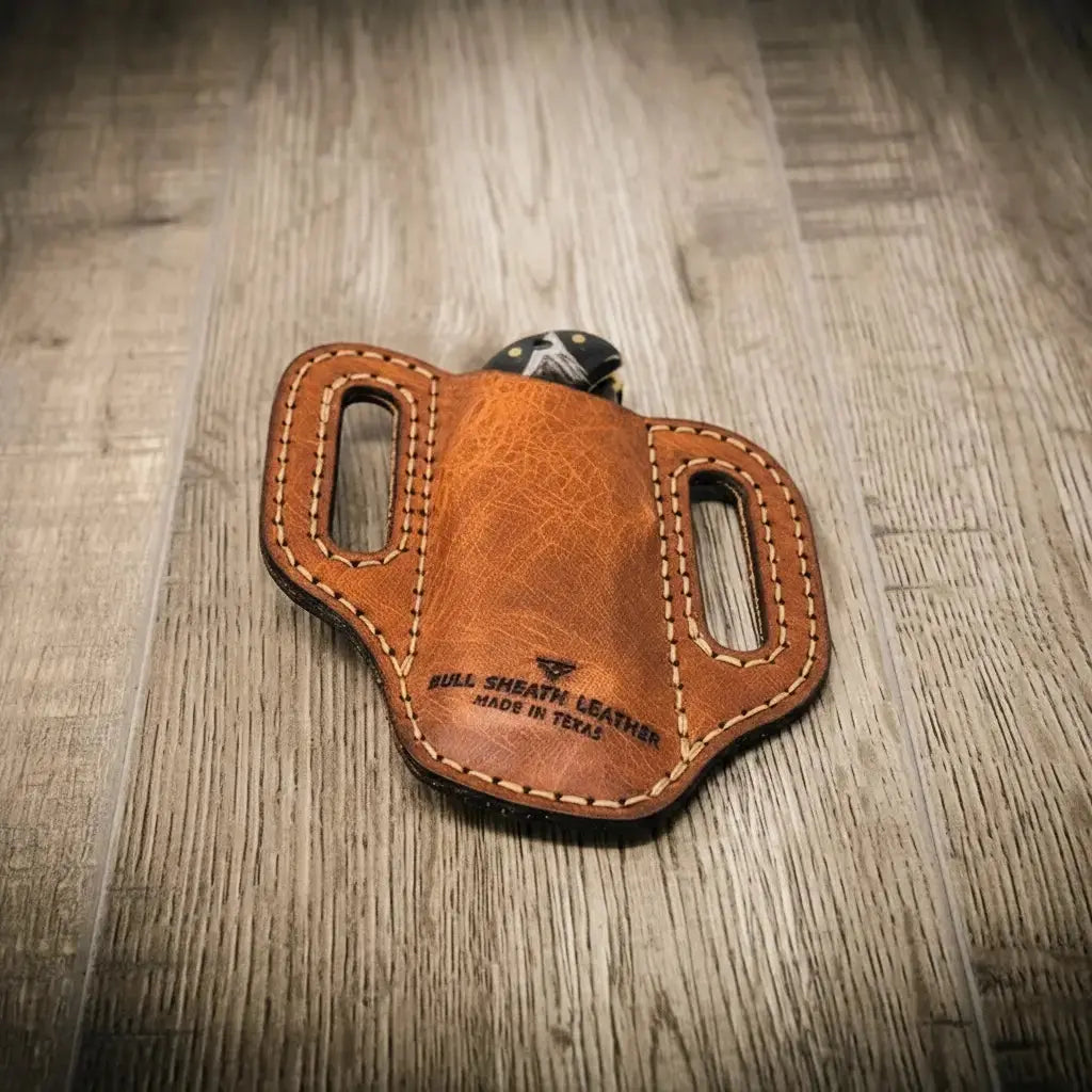 Brown leather knife sheath with "Bull Sheath Leather, Made in Texas" stamped on it.
