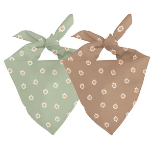 Two daisy print dog bandanas, one green and one brown, tied at the neck.