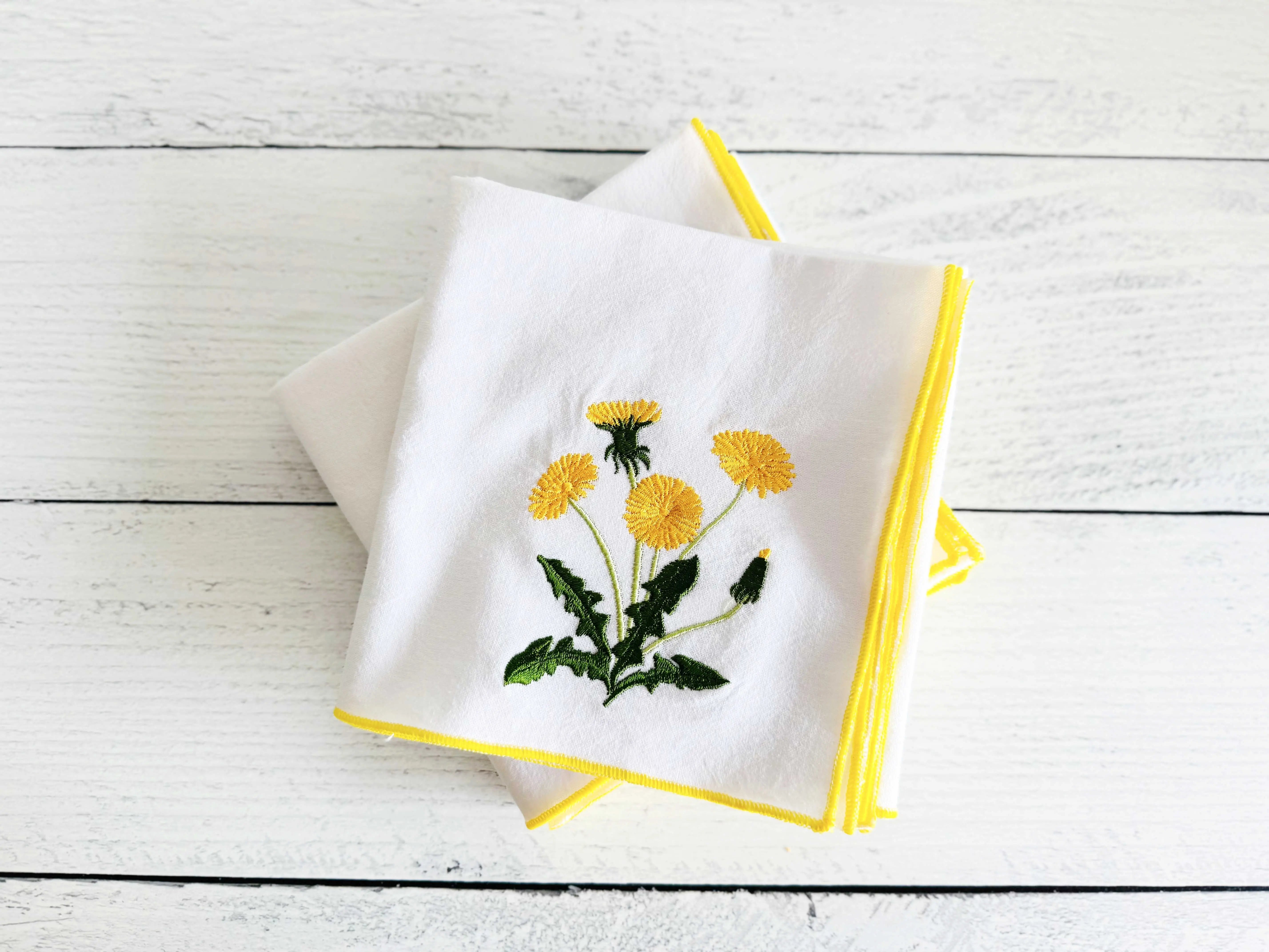 Dandelion embroidered white flour sack towels with yellow trim, set of two