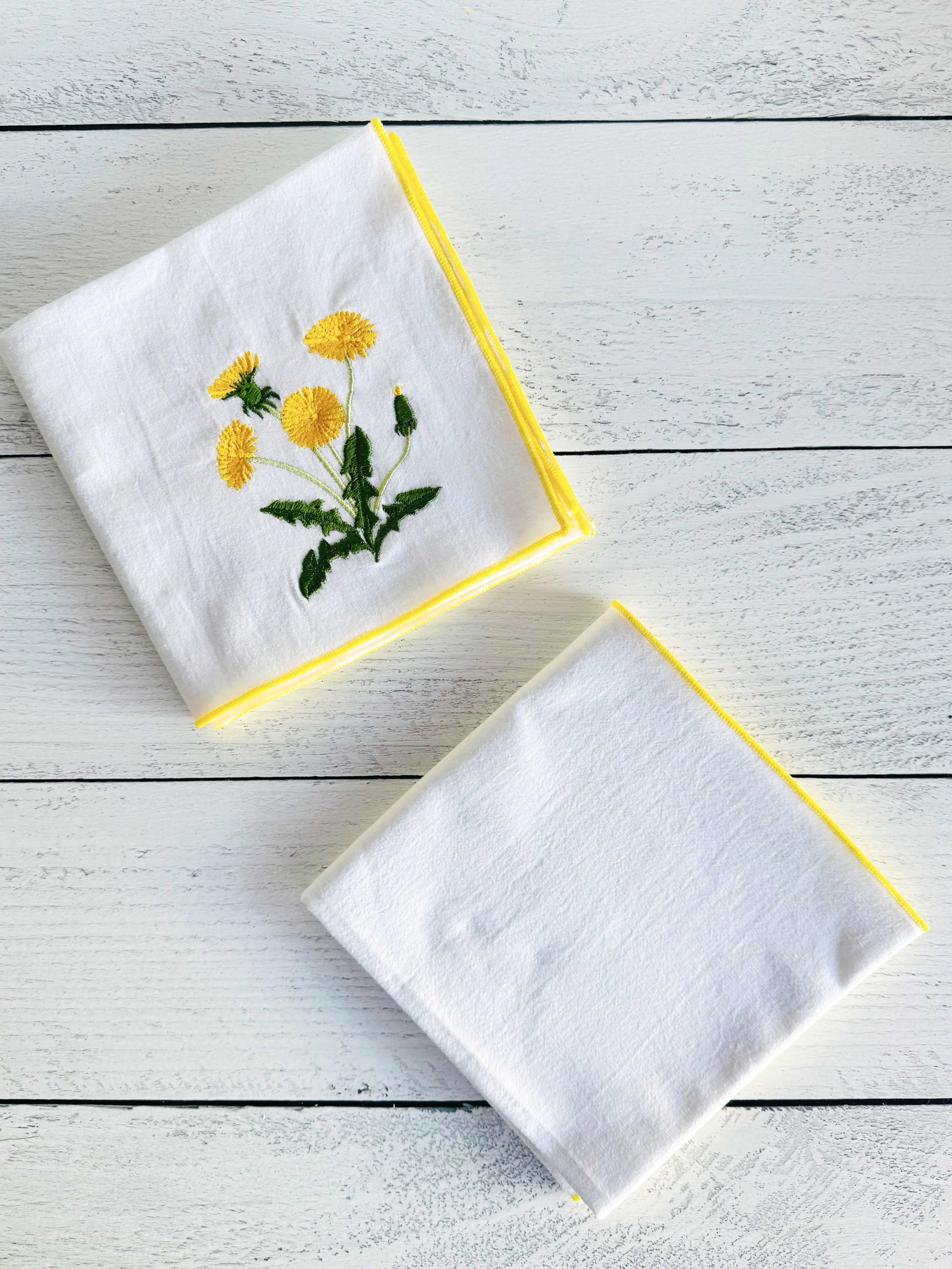 Embroidered dandelion flour sack towels with yellow trim, set of two.