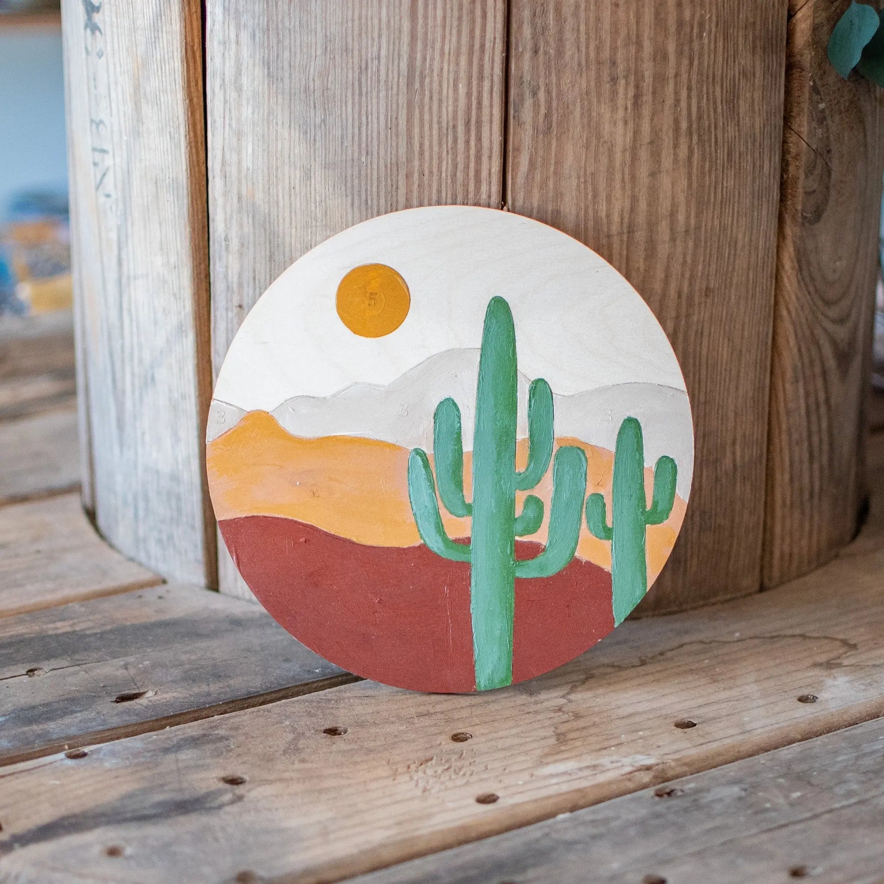 Paint by Number kit with desert landscape on wood disc
