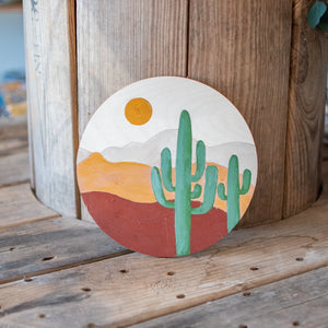 Paint by Number kit with desert landscape on wood disc
