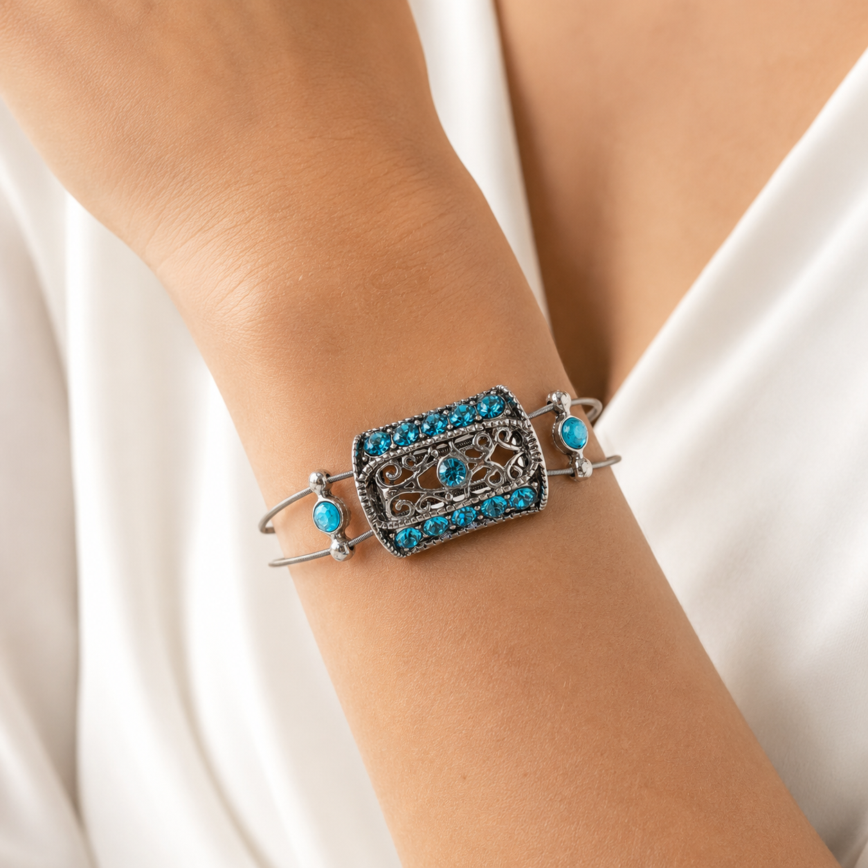 Aqua rhinestone and silver filigree bracelet on wrist