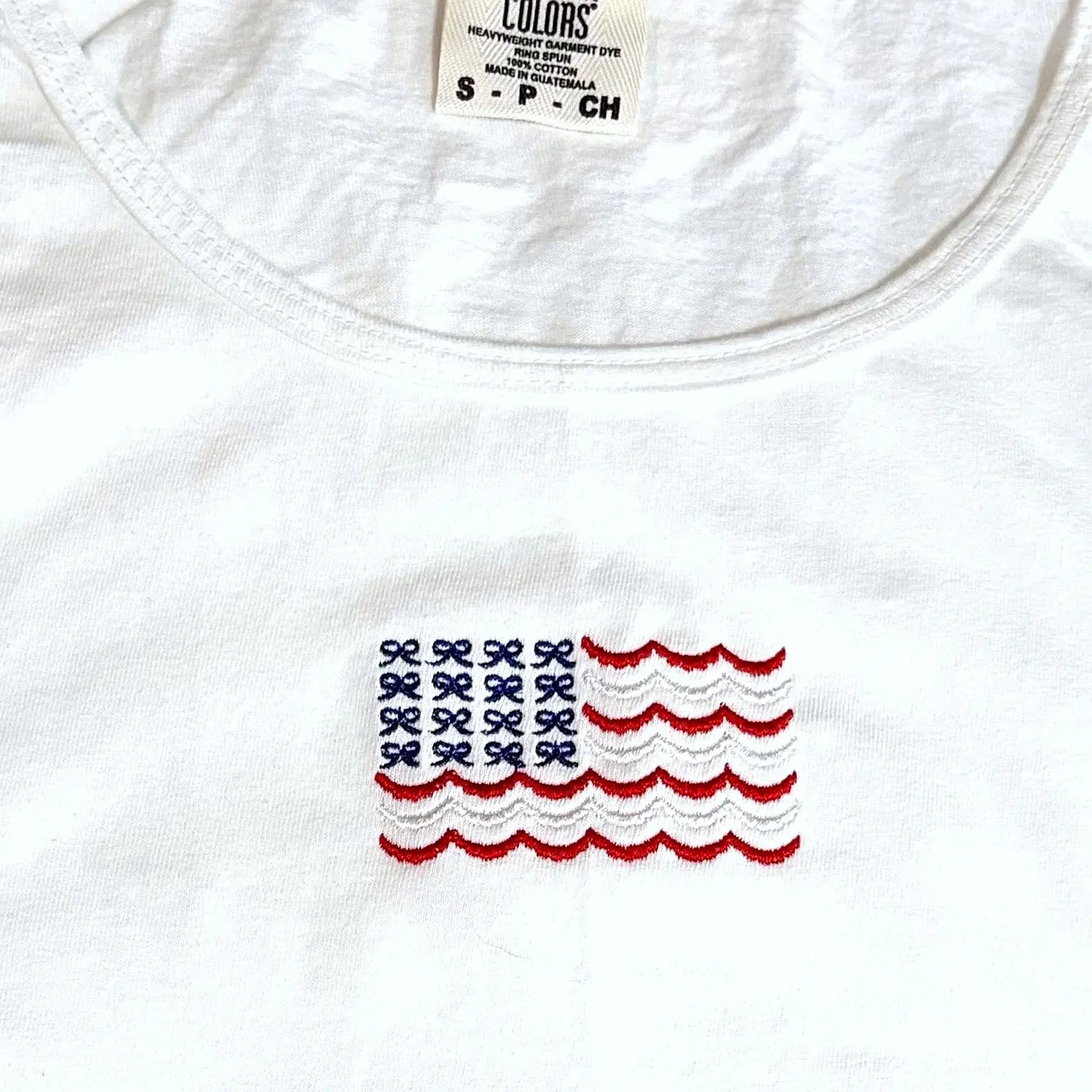 White cotton American flag tank top with embroidered bows.