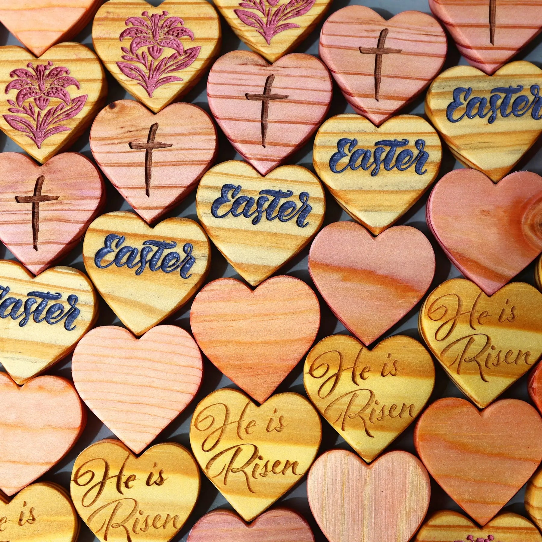 Wooden heart decorations engraved with 'Easter' text and crosses.