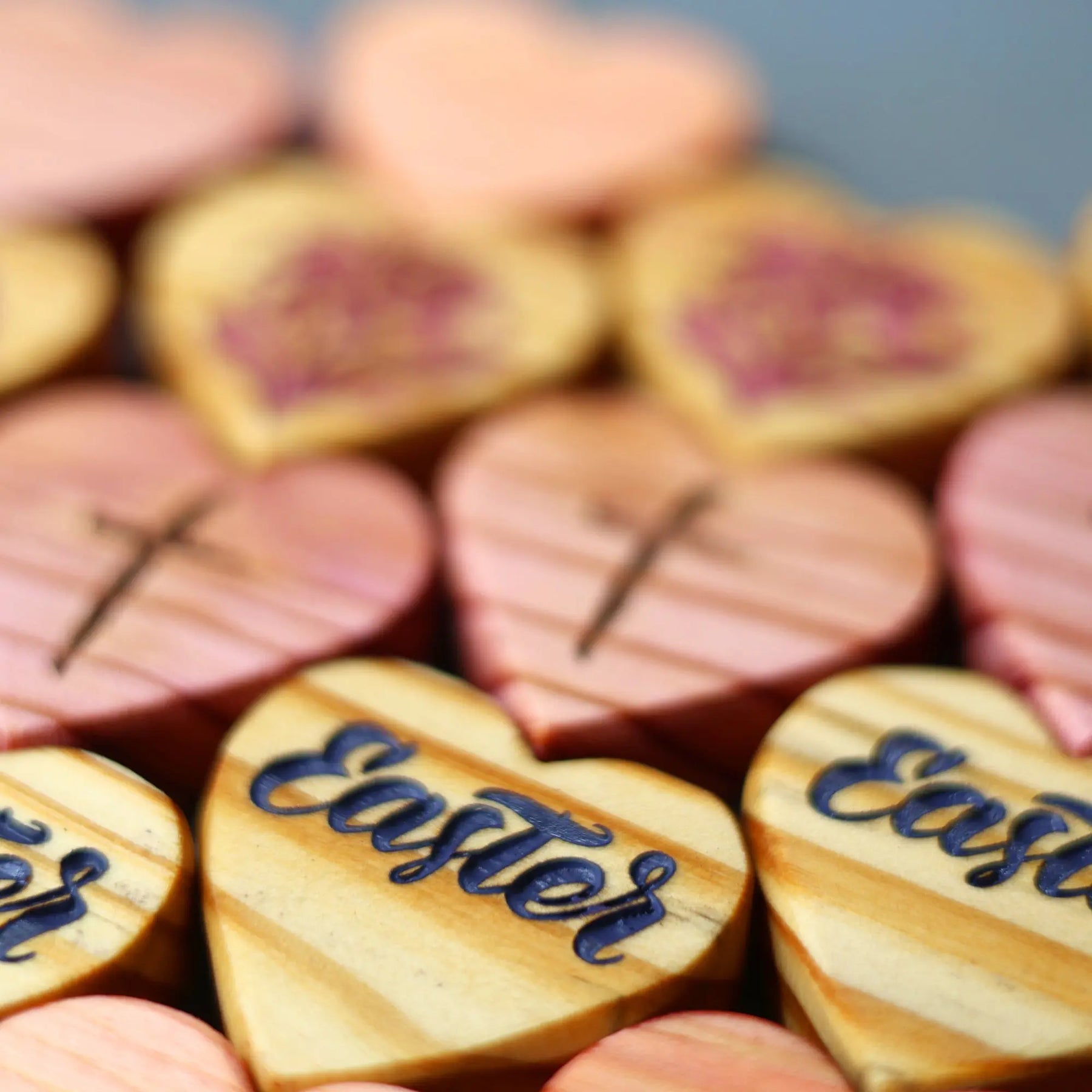 Wooden heart shapes engraved with "Easter" and cross symbols.