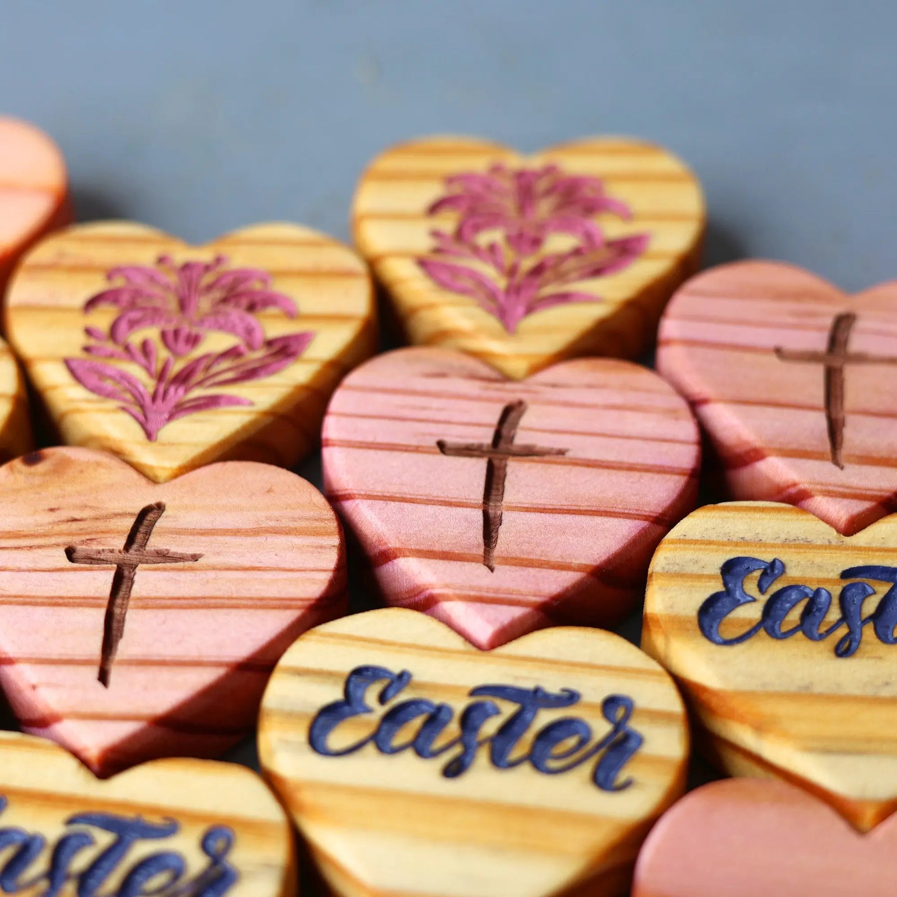 Engraved wooden heart shapes with crosses and floral designs for Easter.