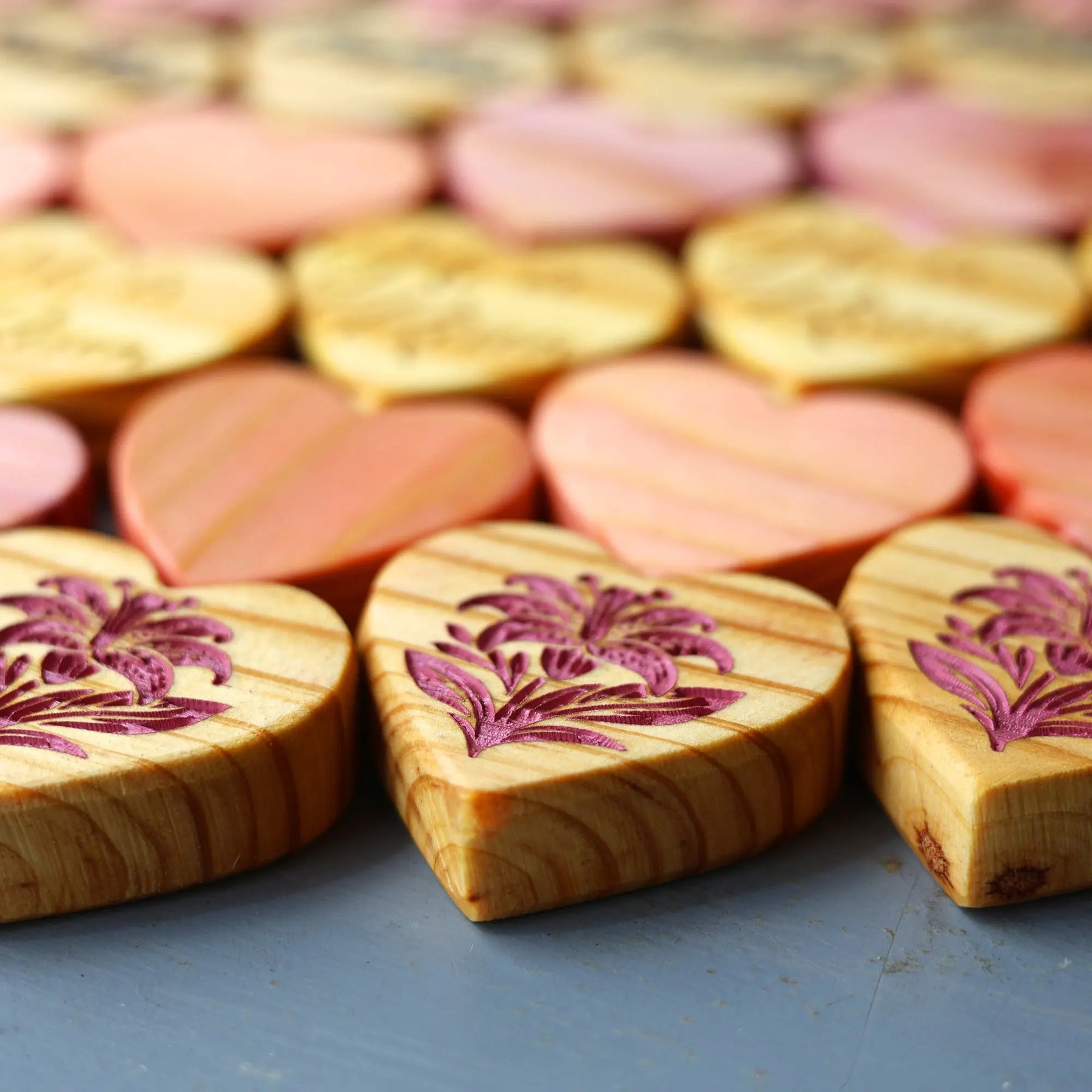 Engraved wooden hearts with floral designs.