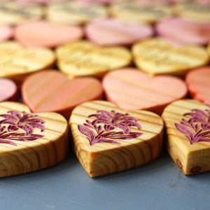 Engraved wooden hearts with floral designs.
