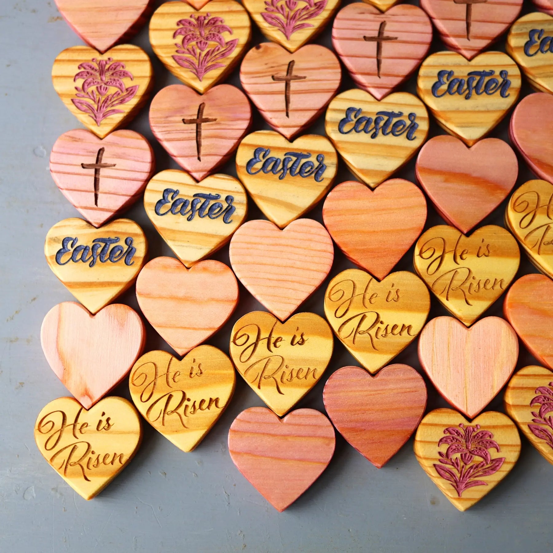 Engraved wooden hearts with Easter messages and religious symbols.