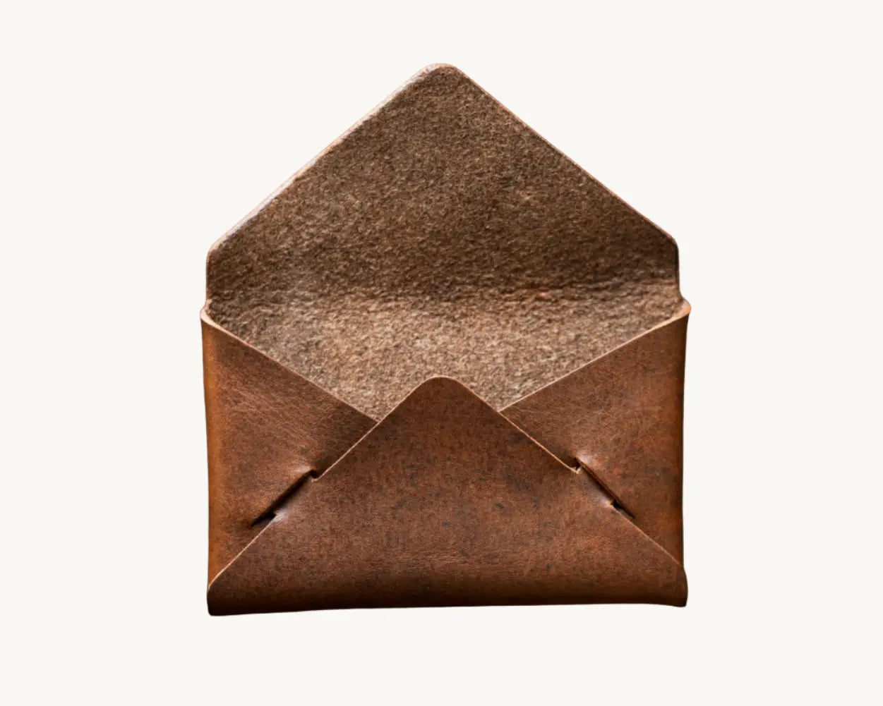 Open brown leather wallet, handmade envelope style, cognac Nemesis leather texture.