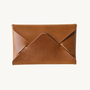 Brown leather envelope wallet on a white background. Minimalist design.