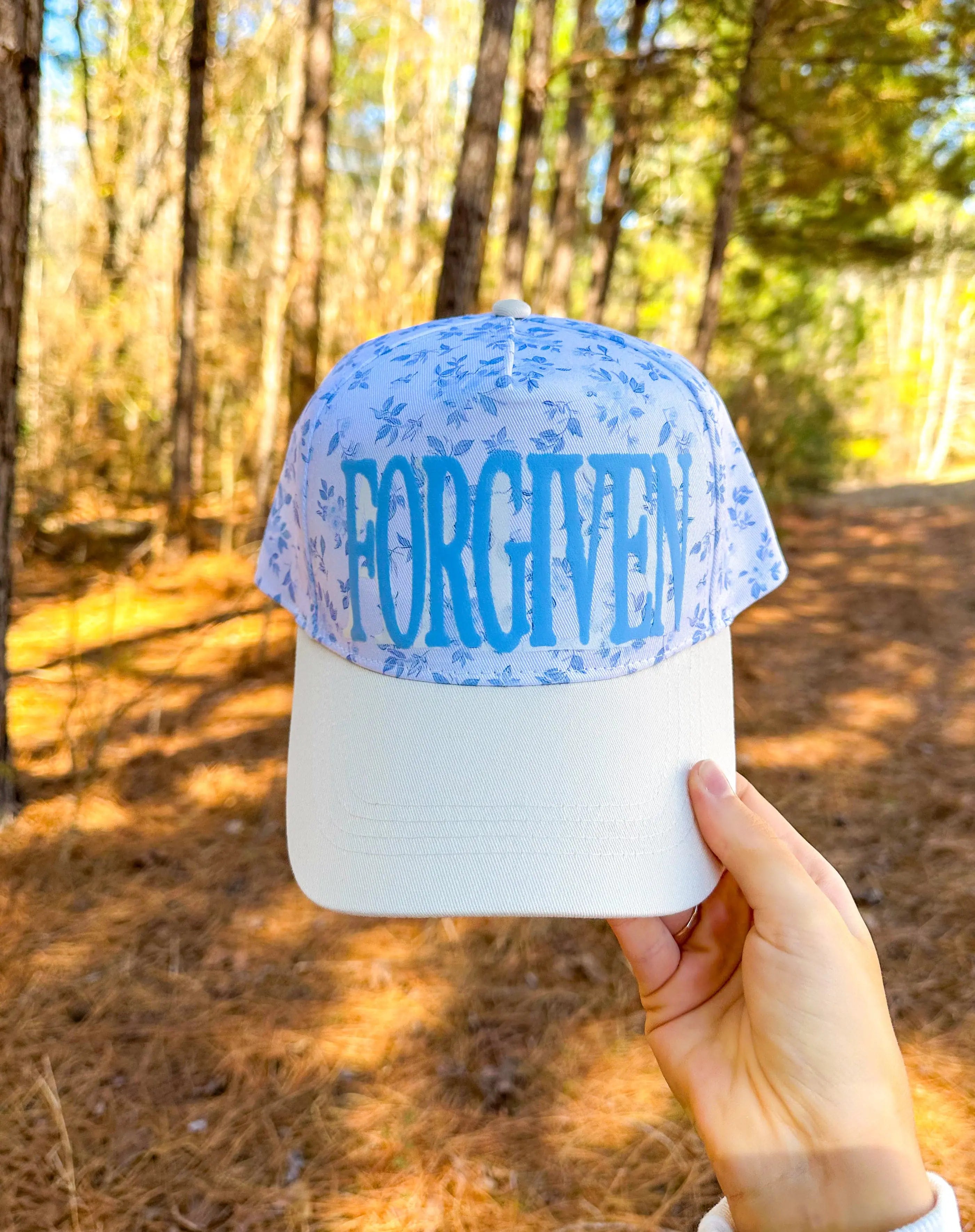 FORGIVEN Floral White/Light Blue Trucker Hat by Southern Bliss Company, Southern lifestyle apparel main product photo