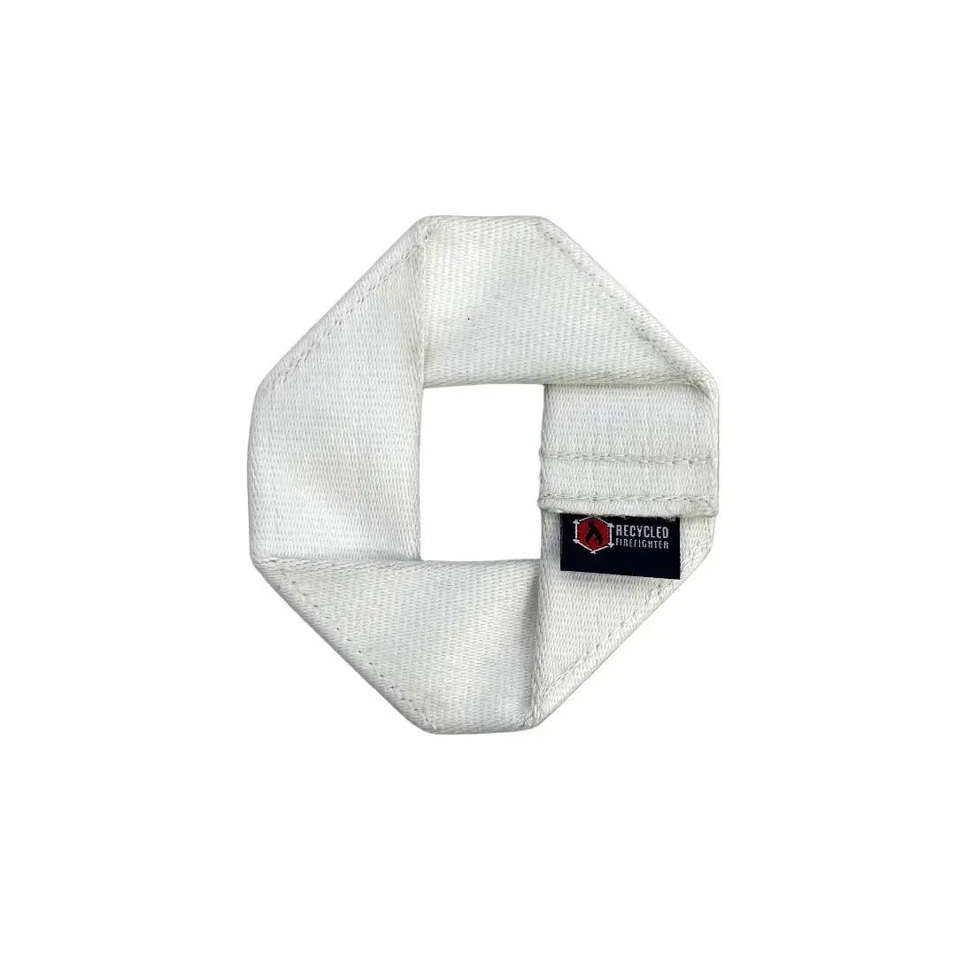 White octagonal dog frisbee made from fire hose with Recycled Firefighter tag.