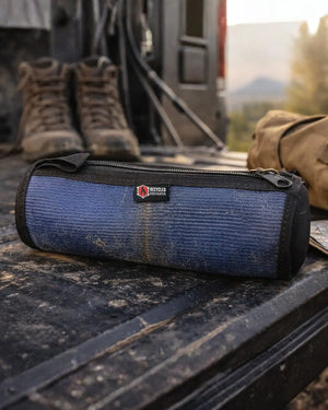 Blue and black toiletry bag made from fire hose material.