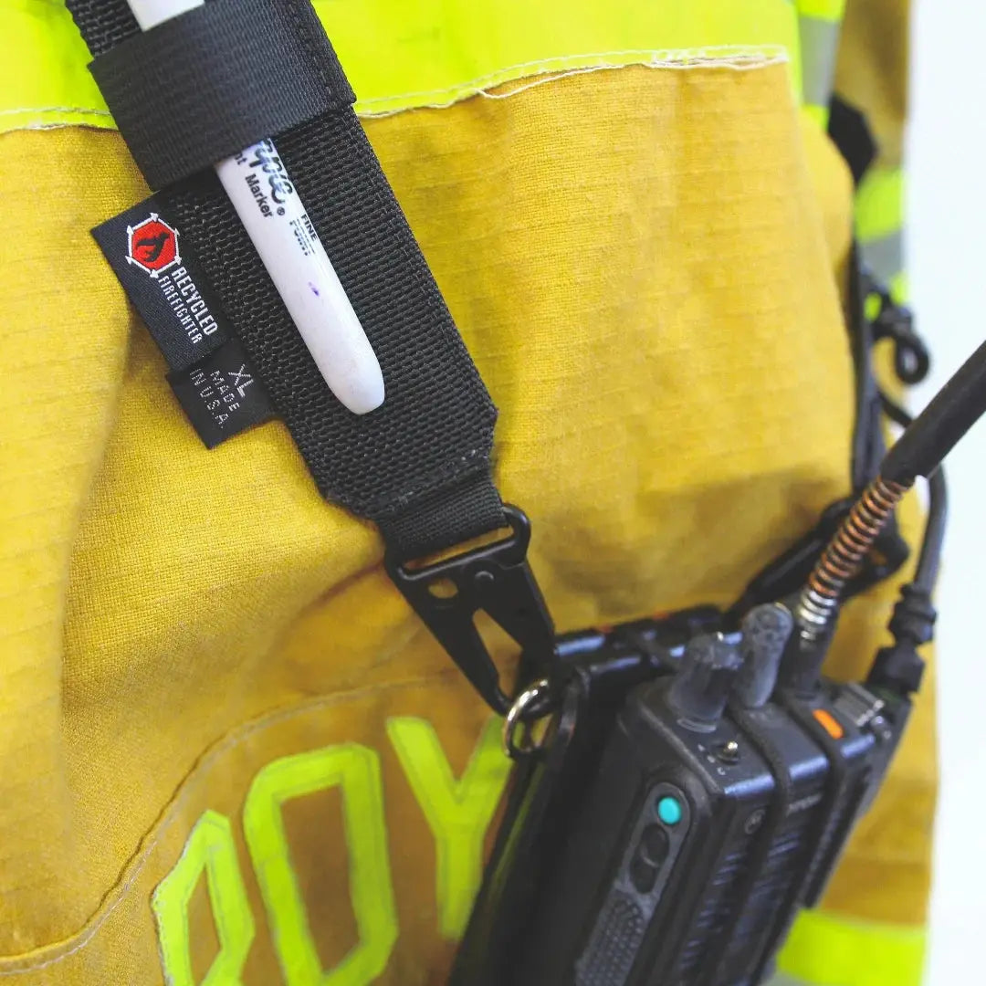 Black nylon firefighter radio strap with pen holder and attached radios
