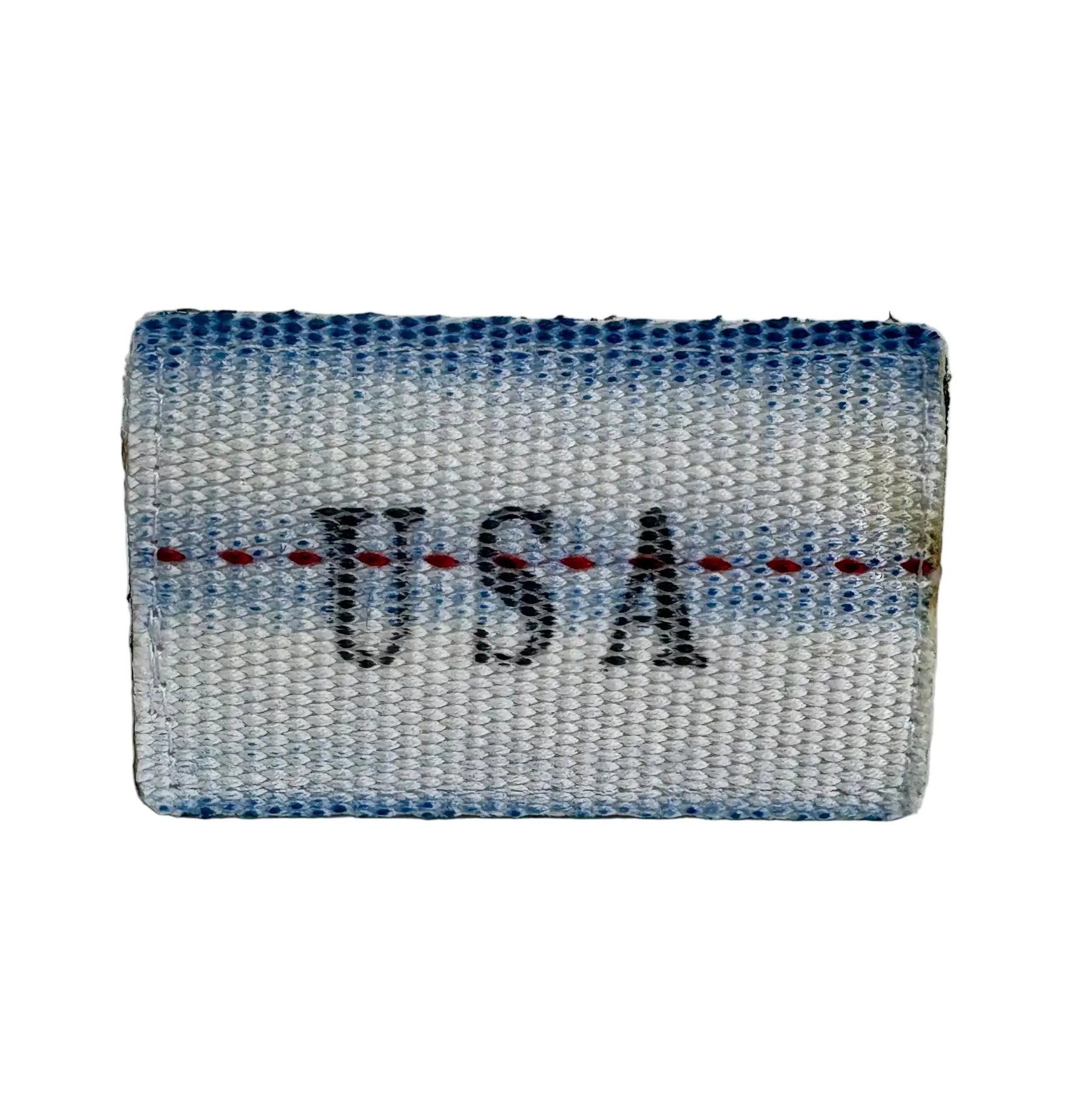 USA made firehose patch with blue and white woven texture and red stitch detail.