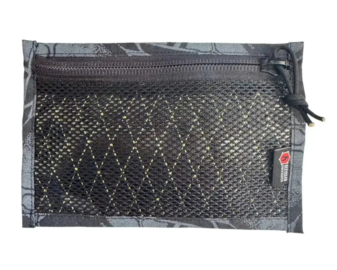 Flat black mesh pouch with zippered top and patterned trim.