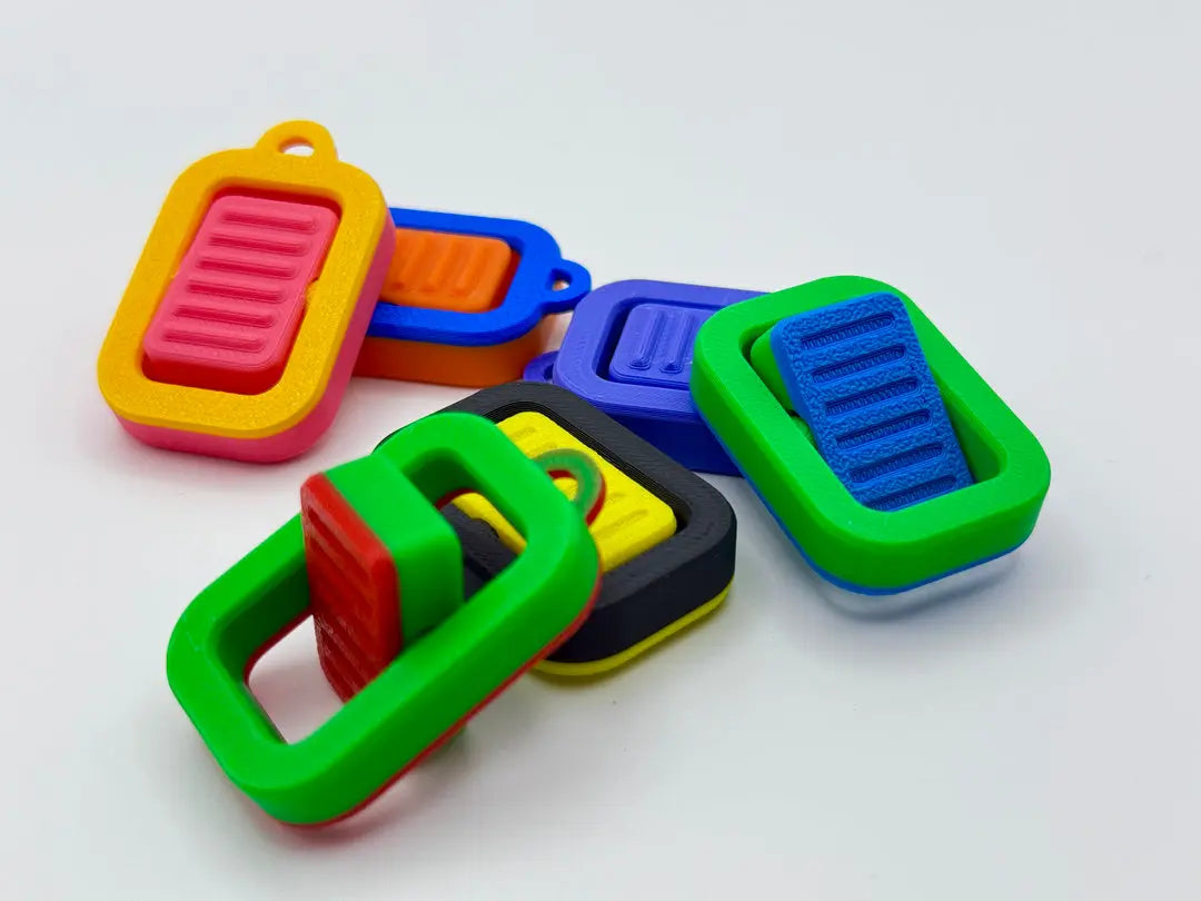 The Tween Space Flip Switch Fidget wholesale bulk sensory keychain fidgets in assorted colors