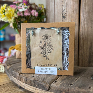 Wooden flower press kit with floral design and paper shreds