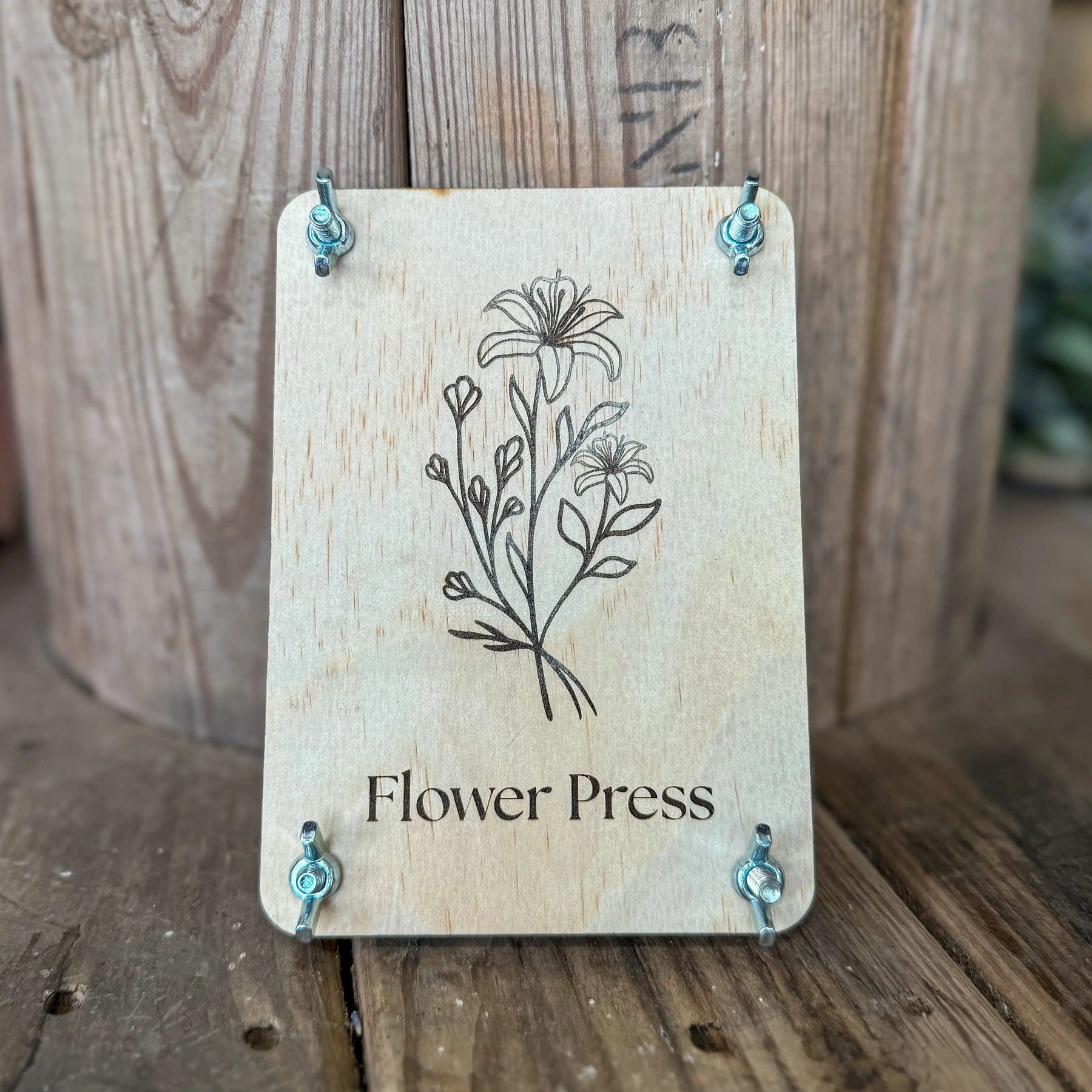 Wooden flower press with floral design and wing nuts