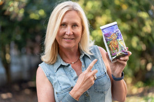 Woman holding a bag of Ginger Quince Goats Milk bath salts with a baby goat design.