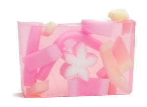 Pink jelly soap with embedded colorful pieces and a white flower shape.