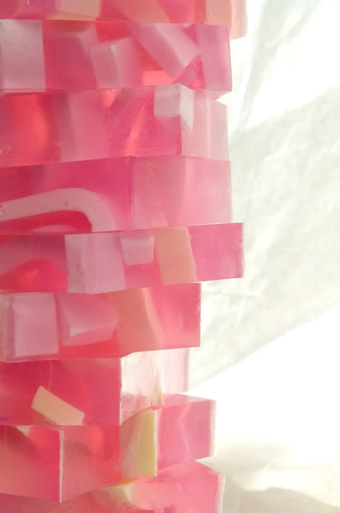 Stack of pink, white, and clear grapefruit splash soap slices.