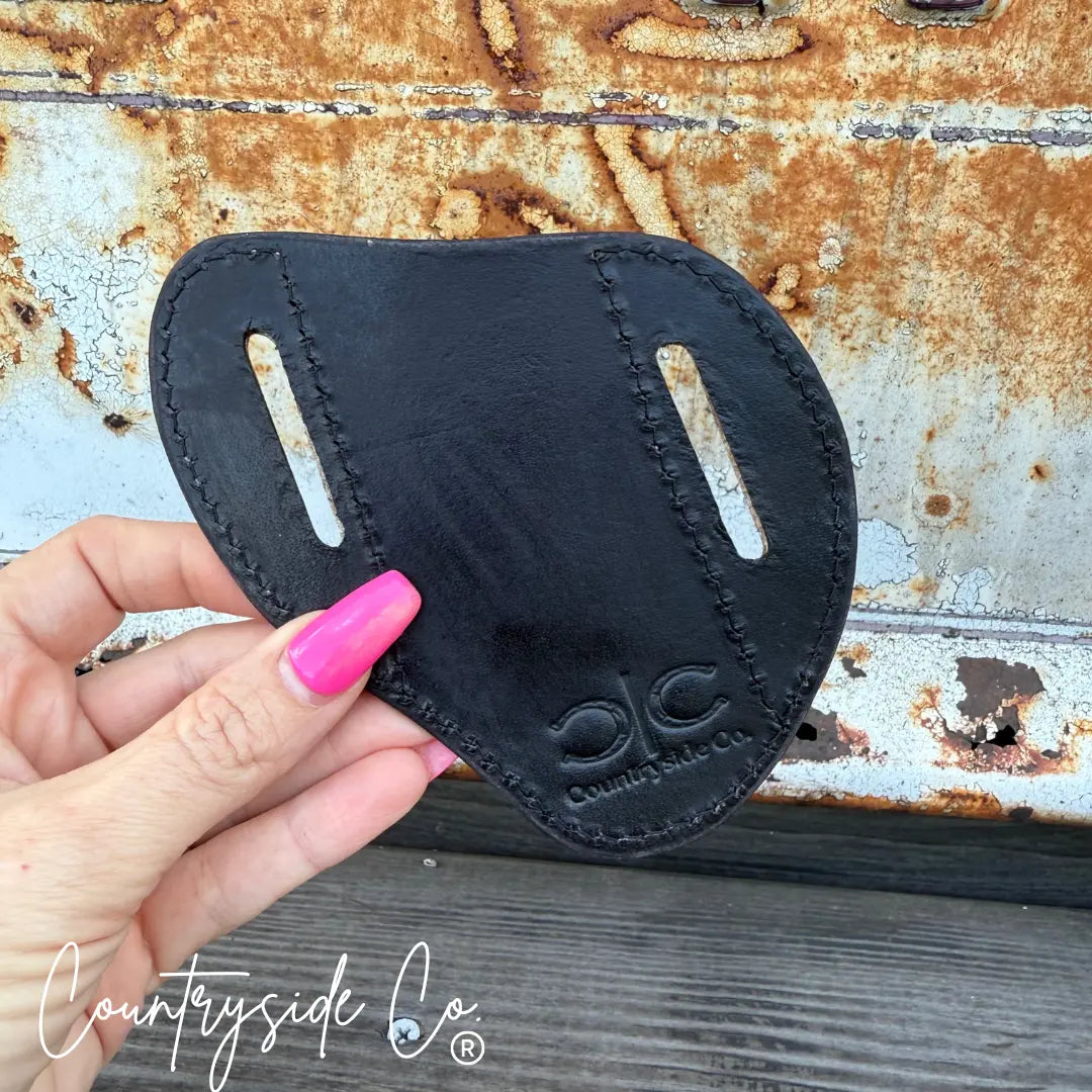 Black tooled leather knife sheath with Countryside Co. logo.
