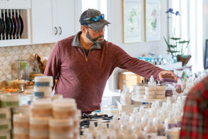 Man selecting lavender mint hemp oil soap bar at Main Street Collective store.