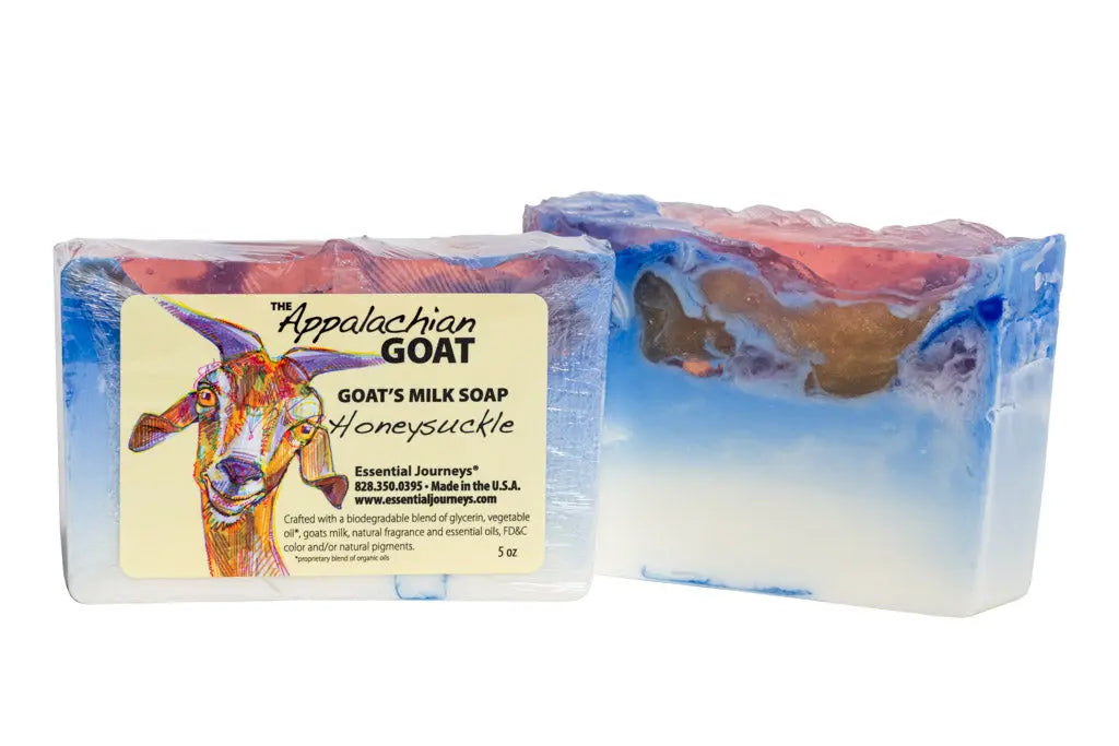 Two bars of honeysuckle goat's milk soap, one with an illustrated label, on a white background.