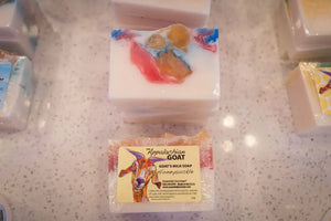 Honeysuckle goat milk soap bar with Essential Journeys label and goat illustration.