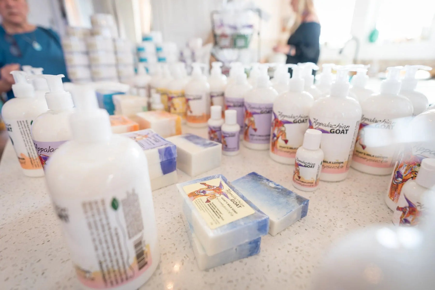 White lotion bottles with "Appalachian Goat" label and goat milk soap bars.
