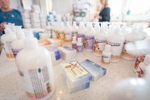 White lotion bottles with "Appalachian Goat" label and goat milk soap bars.