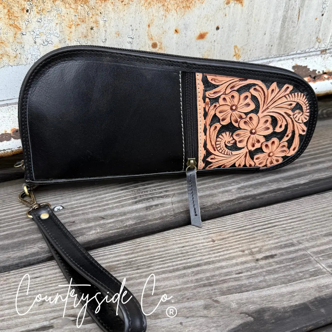 Black leather 12-inch carry case with hand-tooled floral design and detachable wristlet.