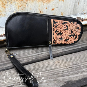 Black leather 12-inch carry case with hand-tooled floral design and detachable wristlet.