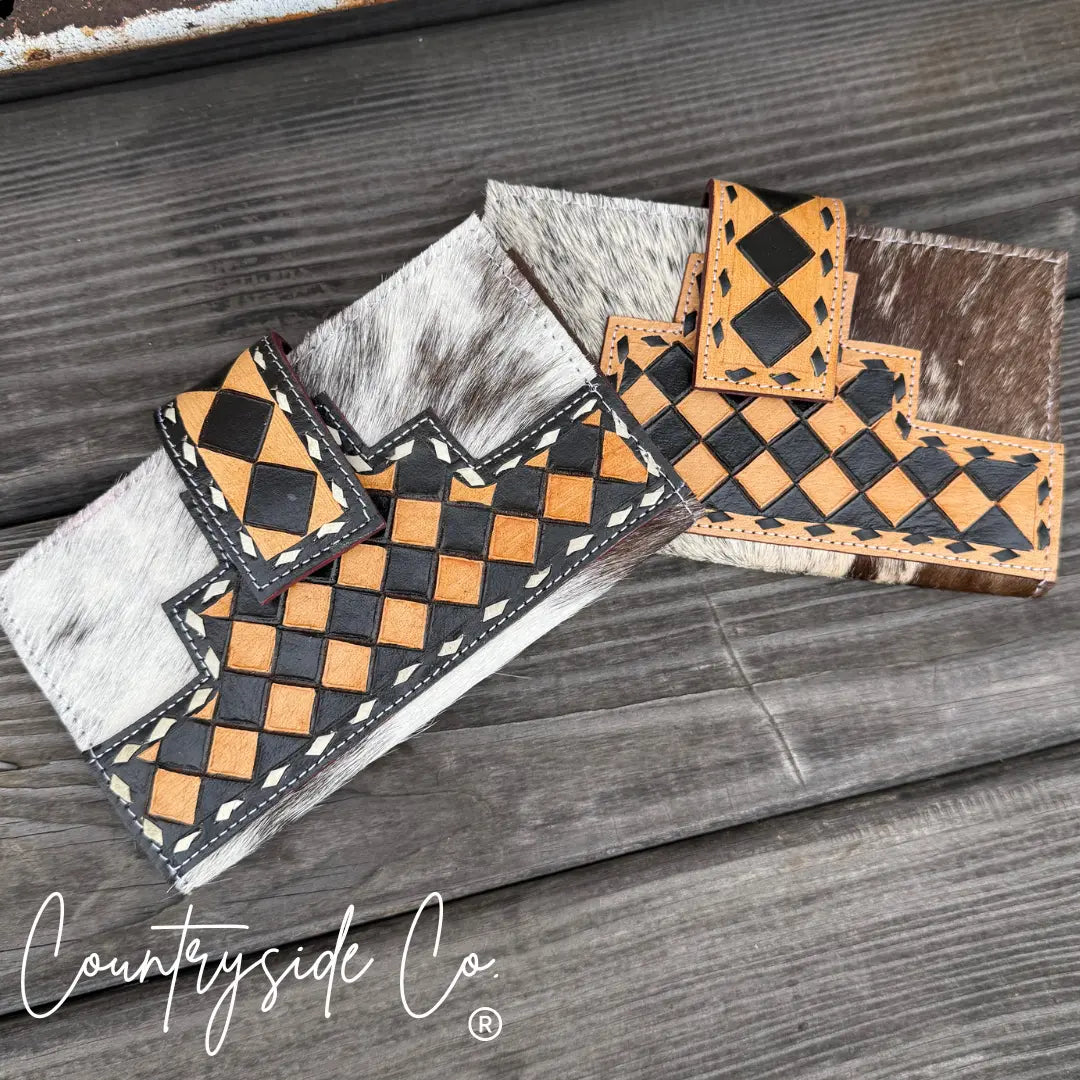 Main Street Collective cowhide wallet with black and tan checkerboard pattern