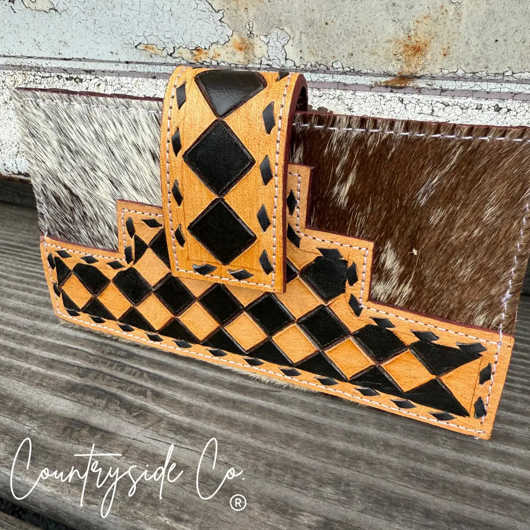 High Plains Checkered Cowhide Wallet with black and tan diamond pattern and snap closure.