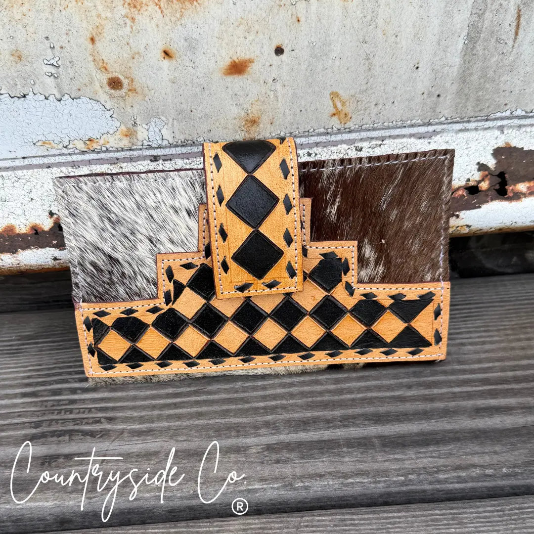 Black and tan checkered cowhide leather wallet with stitch detail.