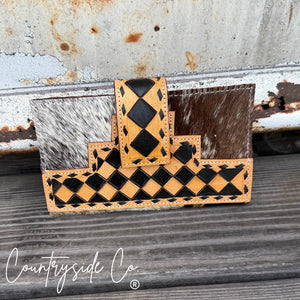 Black and tan checkered cowhide leather wallet with stitch detail.