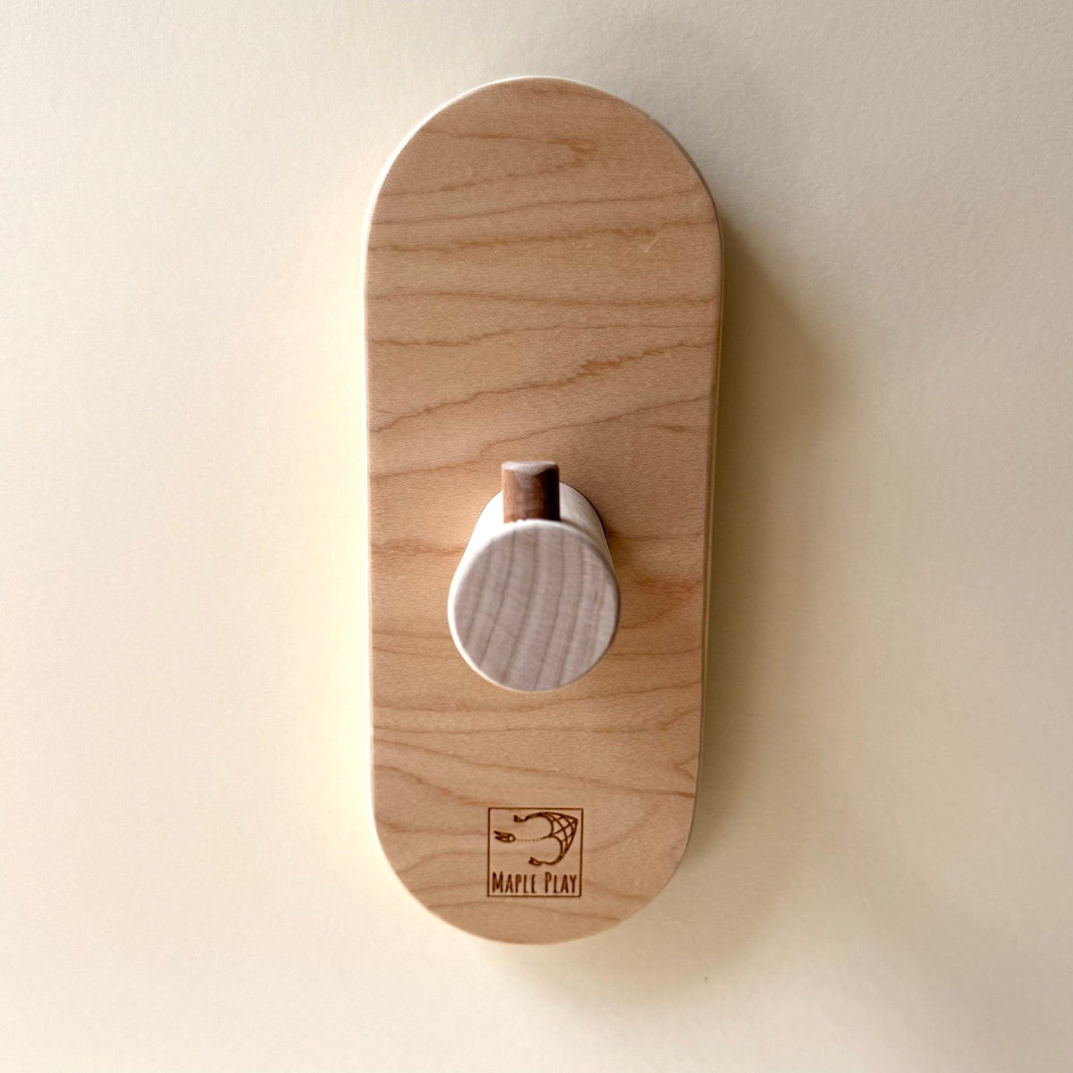 Maple Play wooden wall rack for balance board storage
