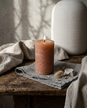 Rustic orange paraffin pillar candle with removable gold charm