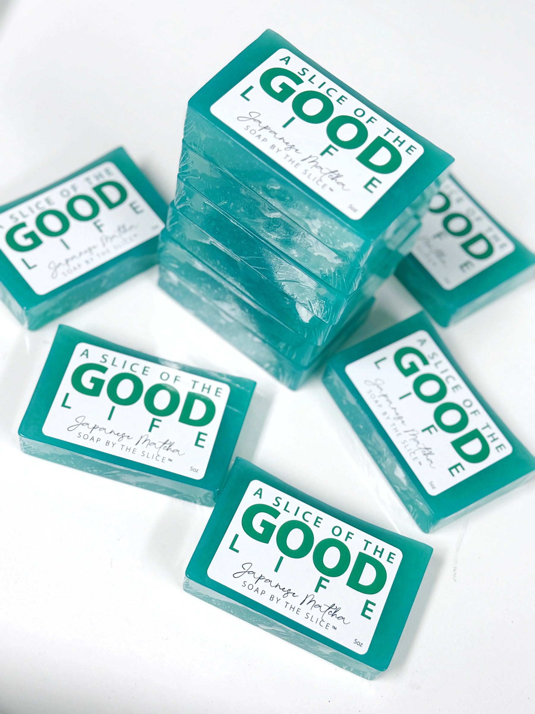 Stack of teal Japanese Matcha soap bars with white labels.