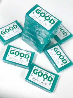 Stack of teal Japanese Matcha soap bars with white labels.