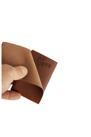 Loyal Stricklin walnut brown leather card wallet being held and opened to show the interior.